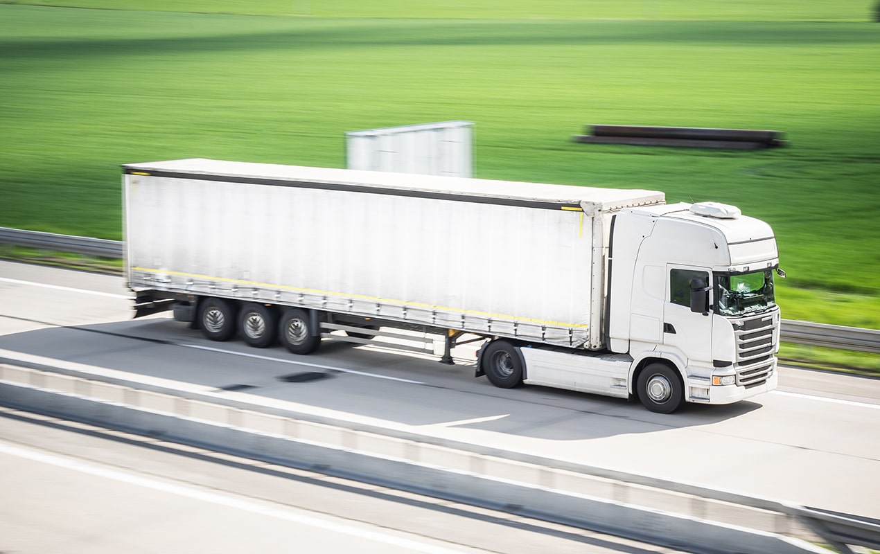 Aerial photo of white truck driving on highway